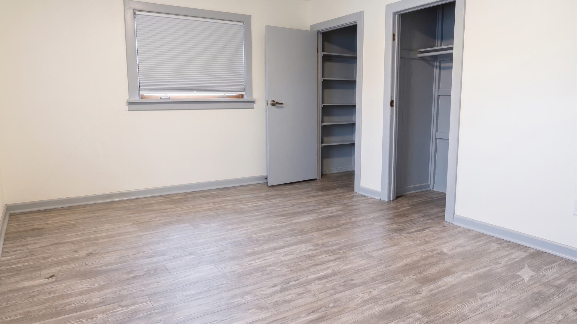 Same bedroom cleaned out, repaired and ready for a new tenant with clean floors and organized closets