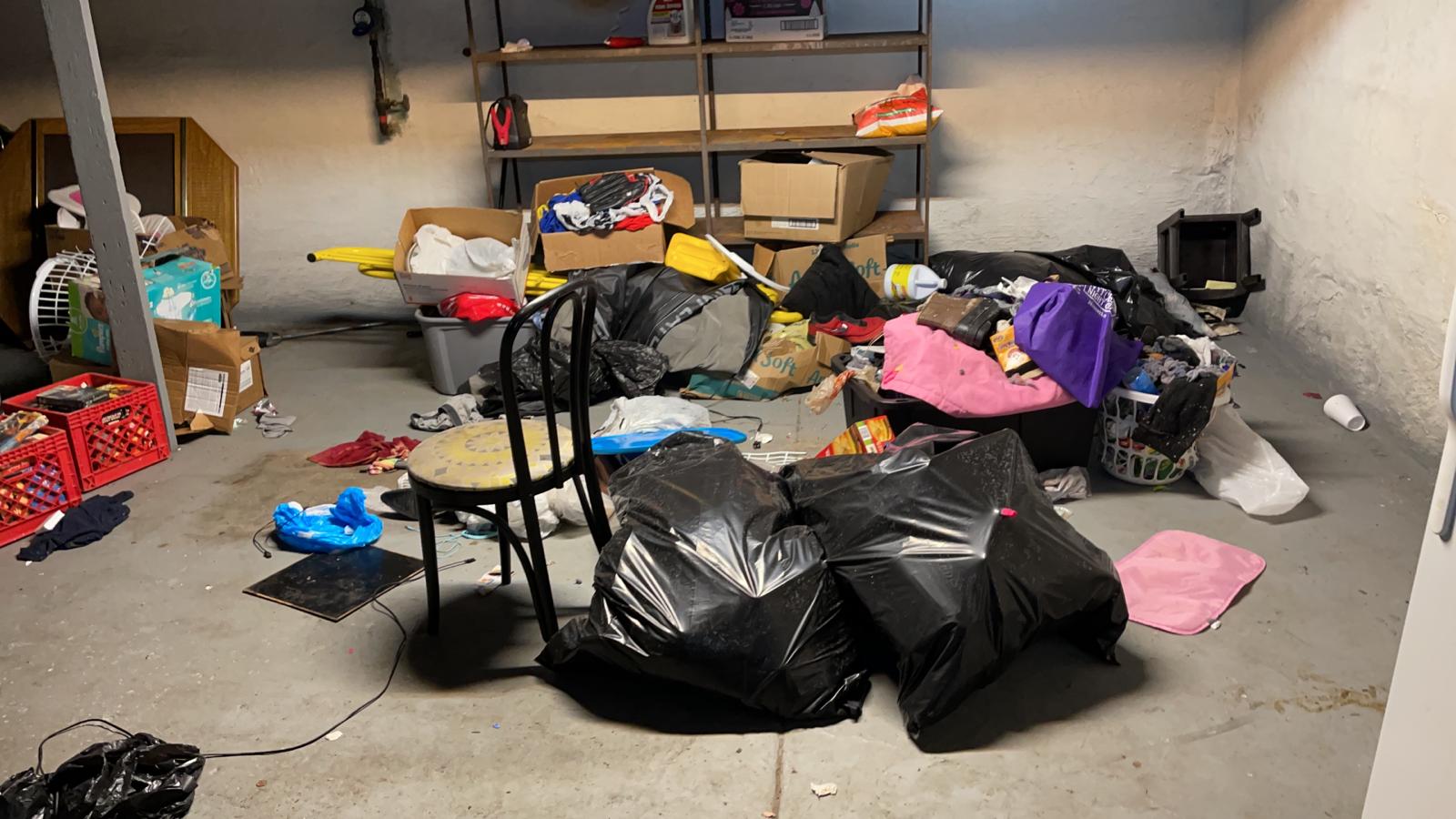 Storage room piled with trash bags, boxes and abandoned belongings left by previous tenant in St. Louis rental